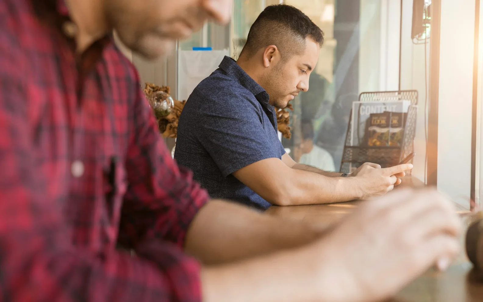 Two colleagues reviewing information together at a table.
