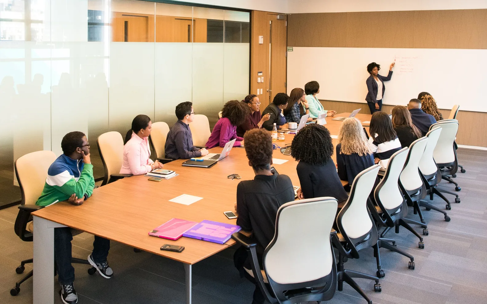Colleagues participating in a discussion around a conference table.