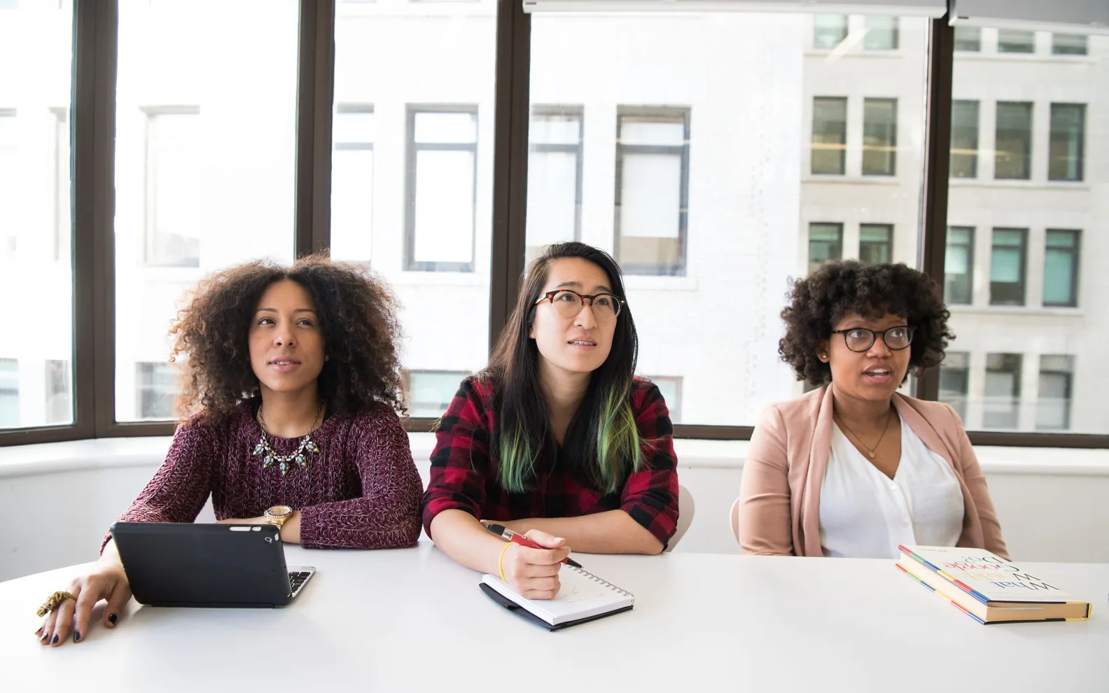 Colleagues listening attentively during a workplace conversation.