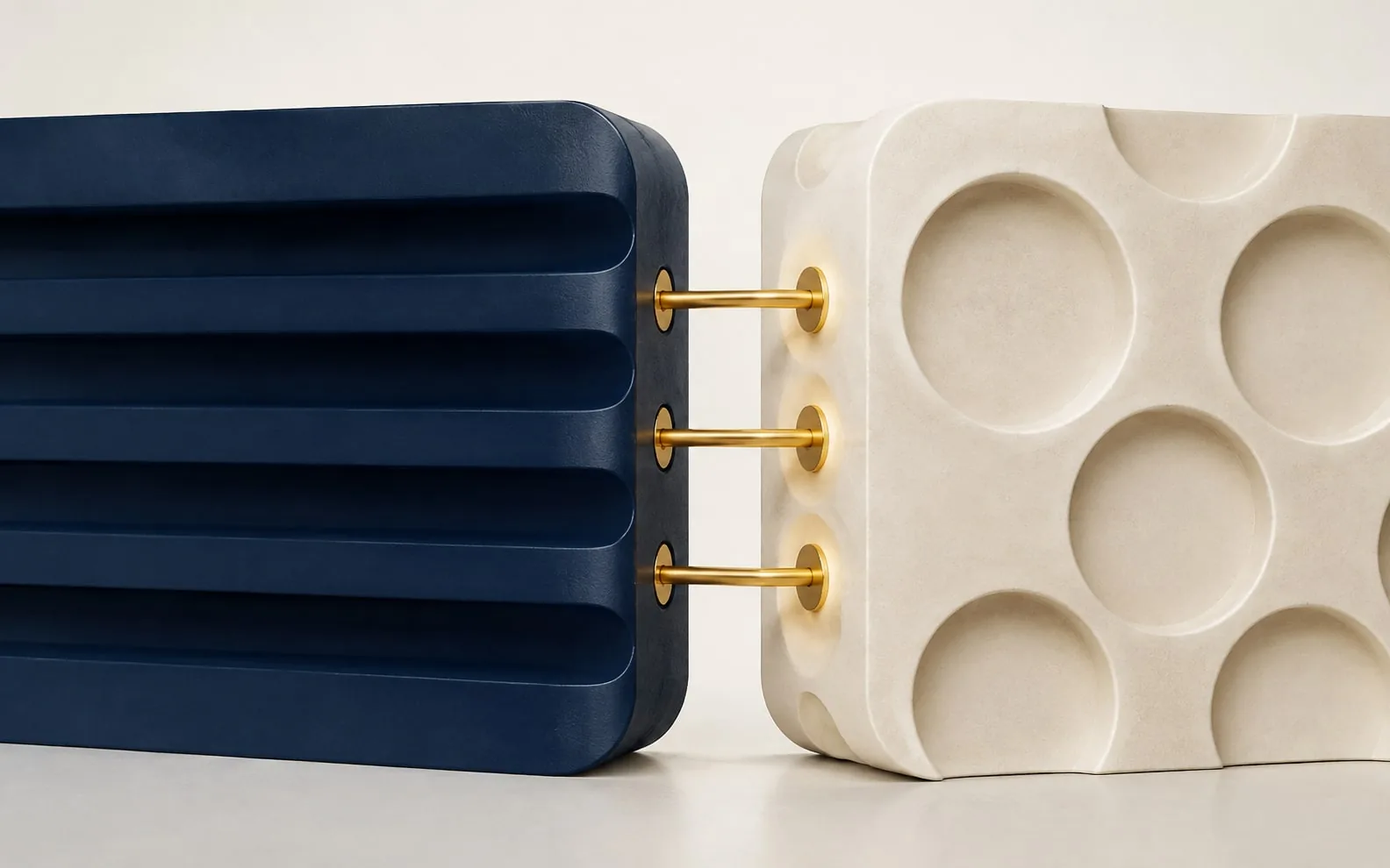 Navy and ivory structures with different surface patterns joined by three gold contact points.